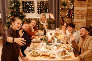family taking photo at christmas mealtime
