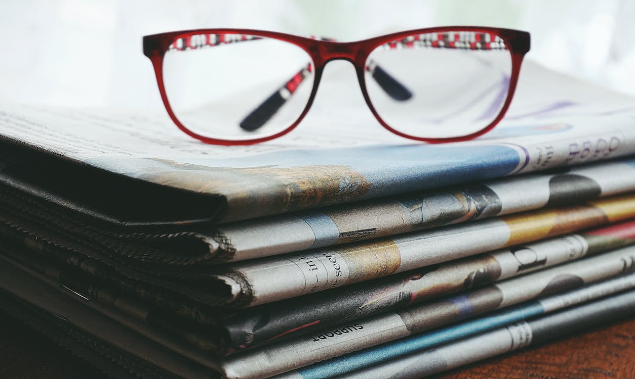 glasses resting on newspaper