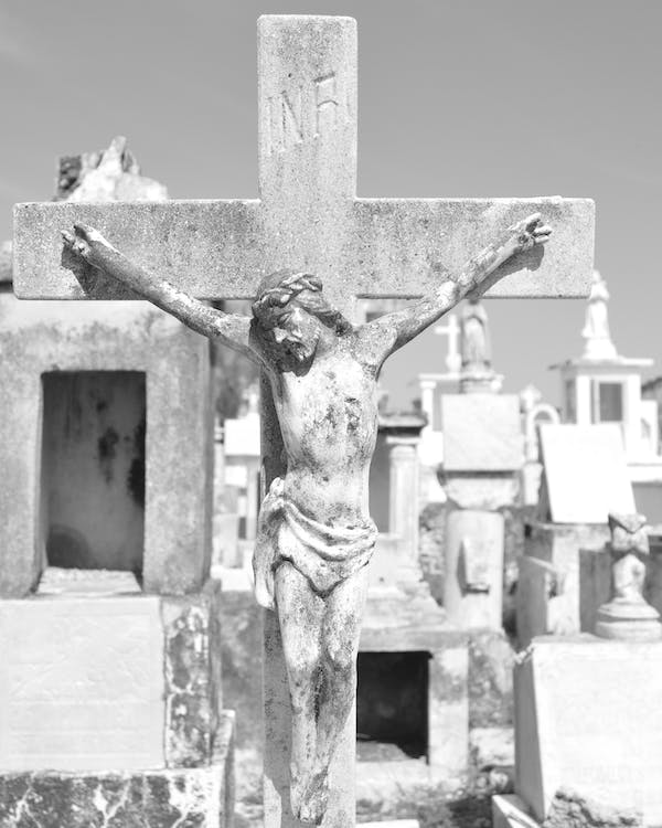 stone cross depicting Christ