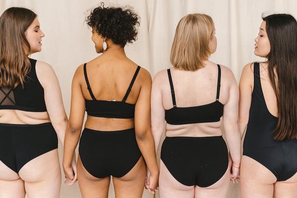 4 females in underwear with backs to camera