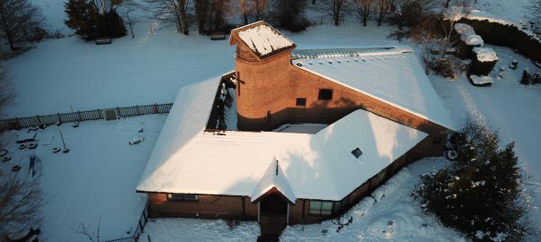 St Mark’s Church, Kempshott. Photo from the air, church covered in snow.