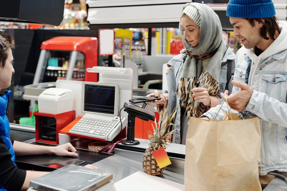 2 people at the supermarket checkout