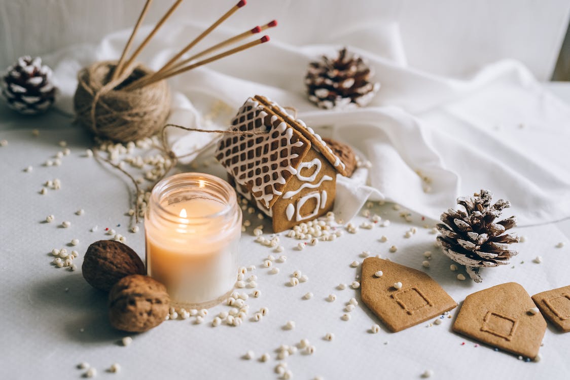 Christmas scene including gingerbread, candle and walnuts