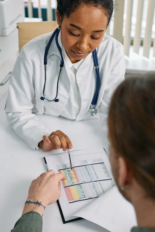 medical professional pointing at medical chart