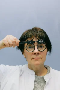 women holding glasses over her face