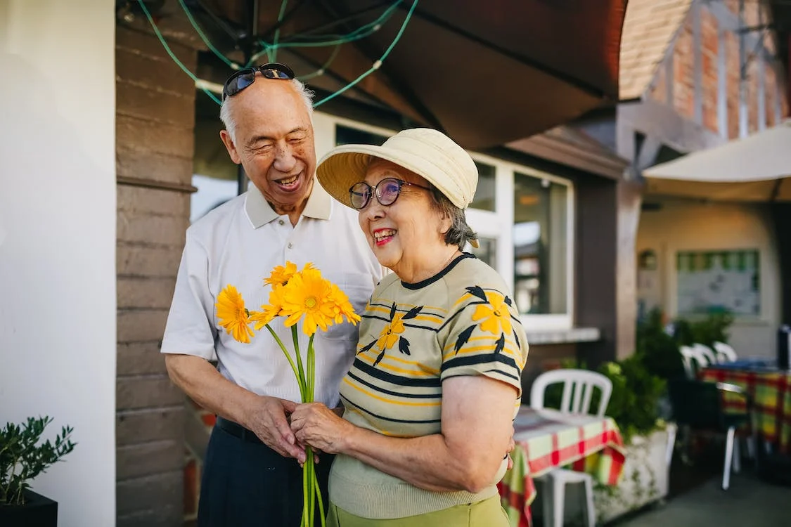 a couple look happy with yellow flowers