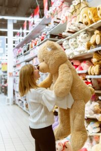 female shopping for a big teddy bear